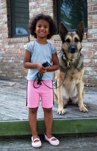 Young girl with German shepherd dog